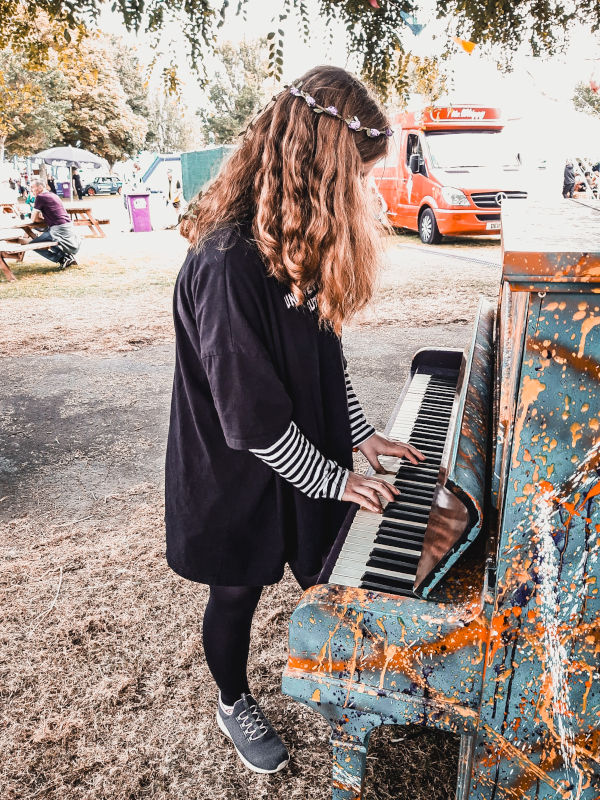 Girl playing on an old piano