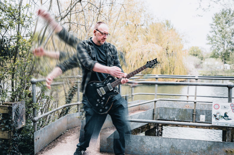 Man doing the windmill with his guitar