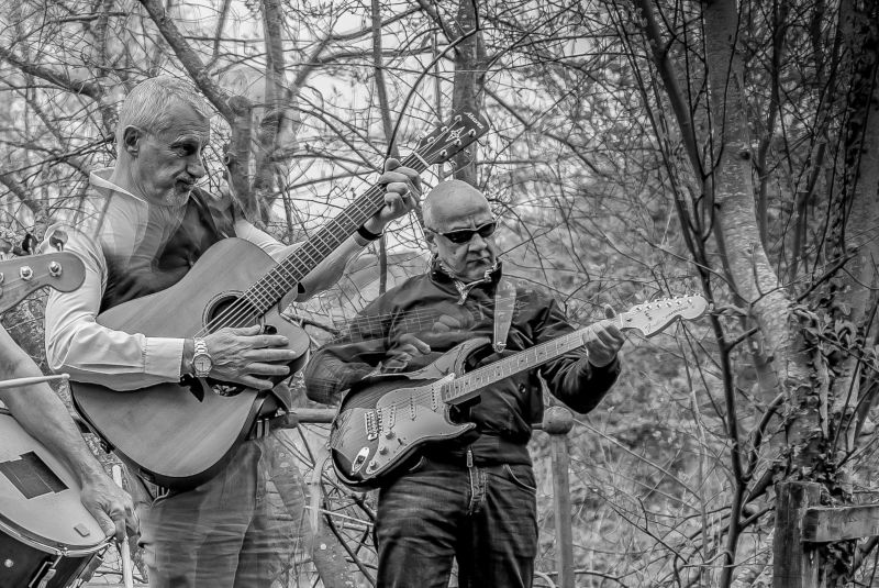 Two men playing guitars